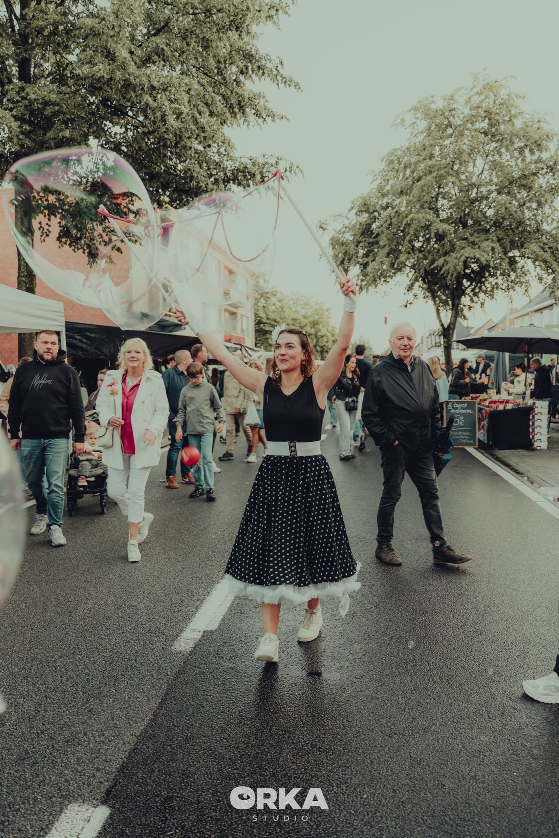 Bellenartiest tussen bezoekers en kraampjes op de braderij van Sint-Antonius