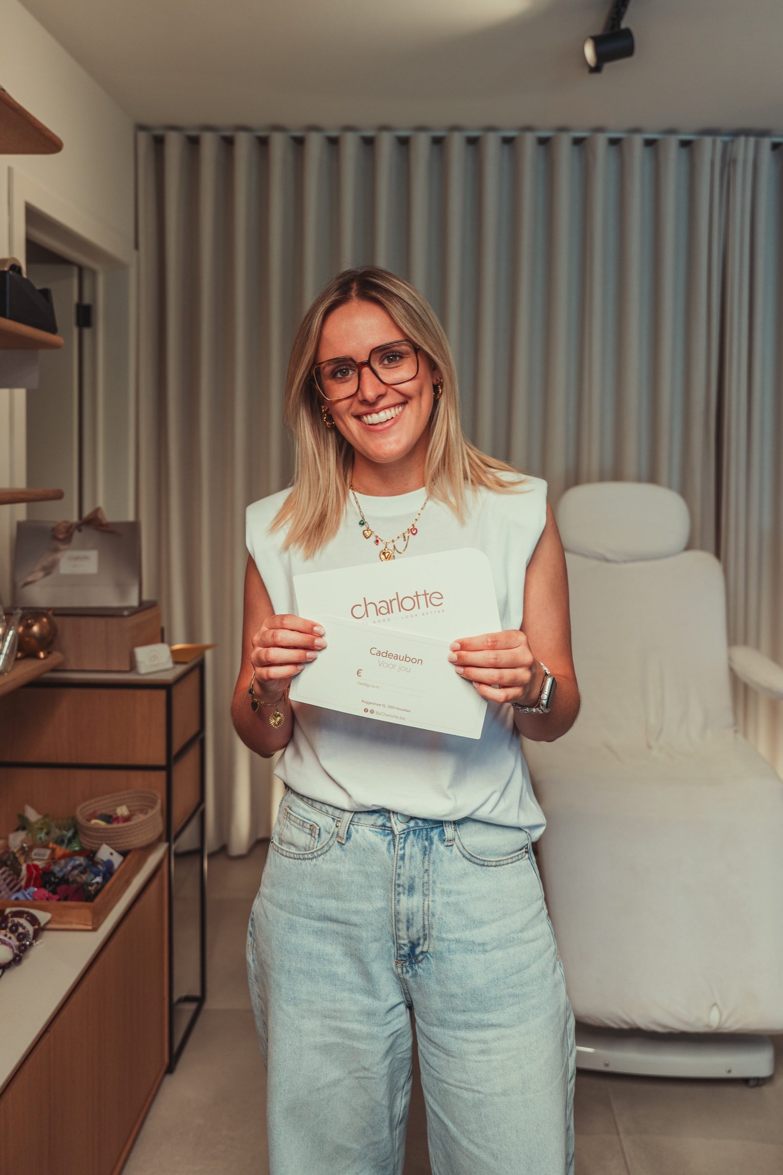 Charlotte met een voucher van haar salon in de hand